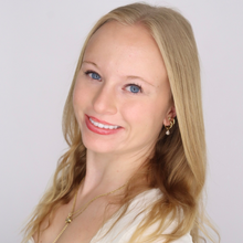 White woman with blond hair in front of white background