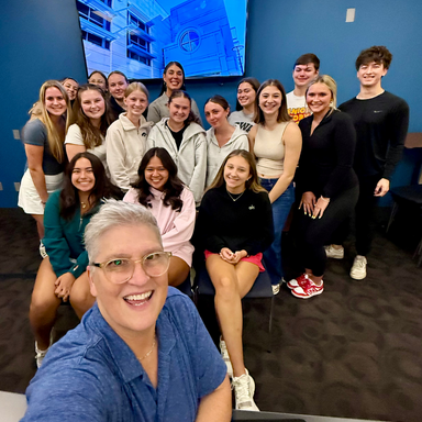 Photo of peole in front of a blue wall