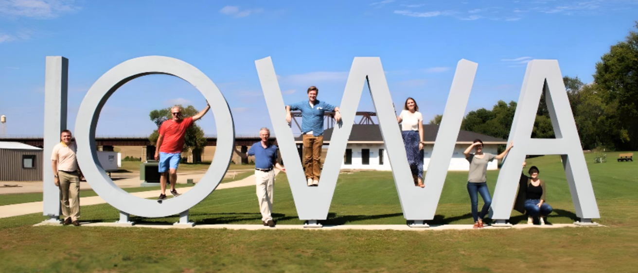 UI students pose with IOWA sculpture in Manning IA