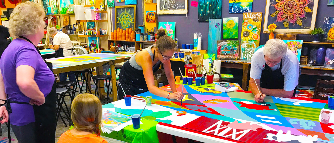 A group paints during a workshop.