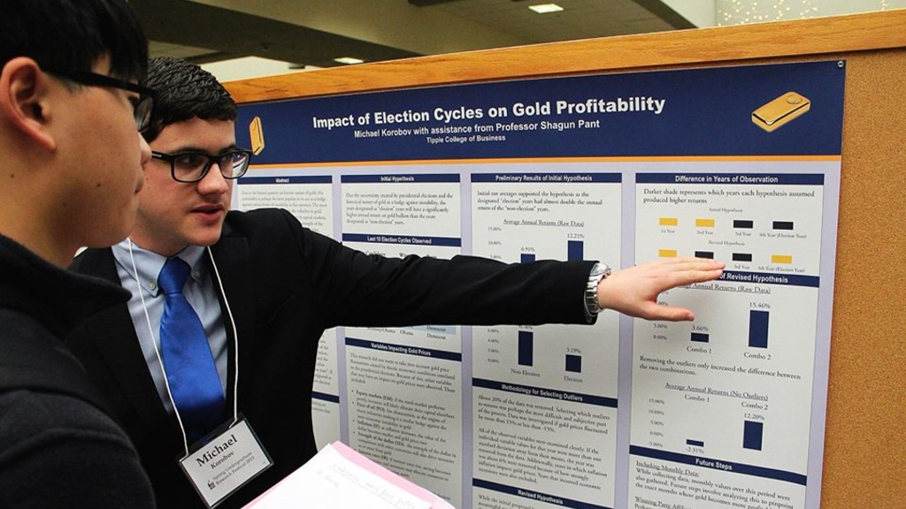 Student Michael shares presentation at research fair