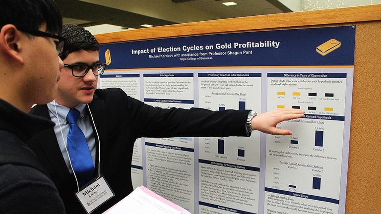 Student Michael shares presentation at research fair