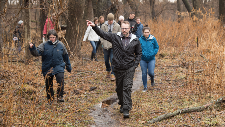 Students attending class in a field