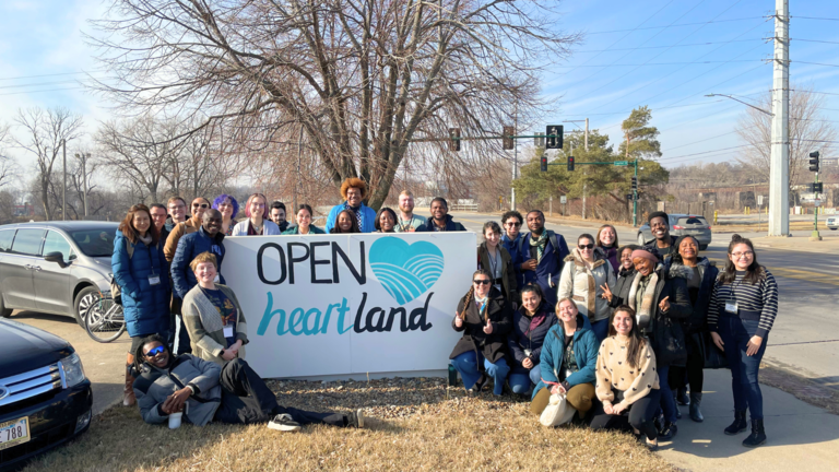 Students outside holding banner